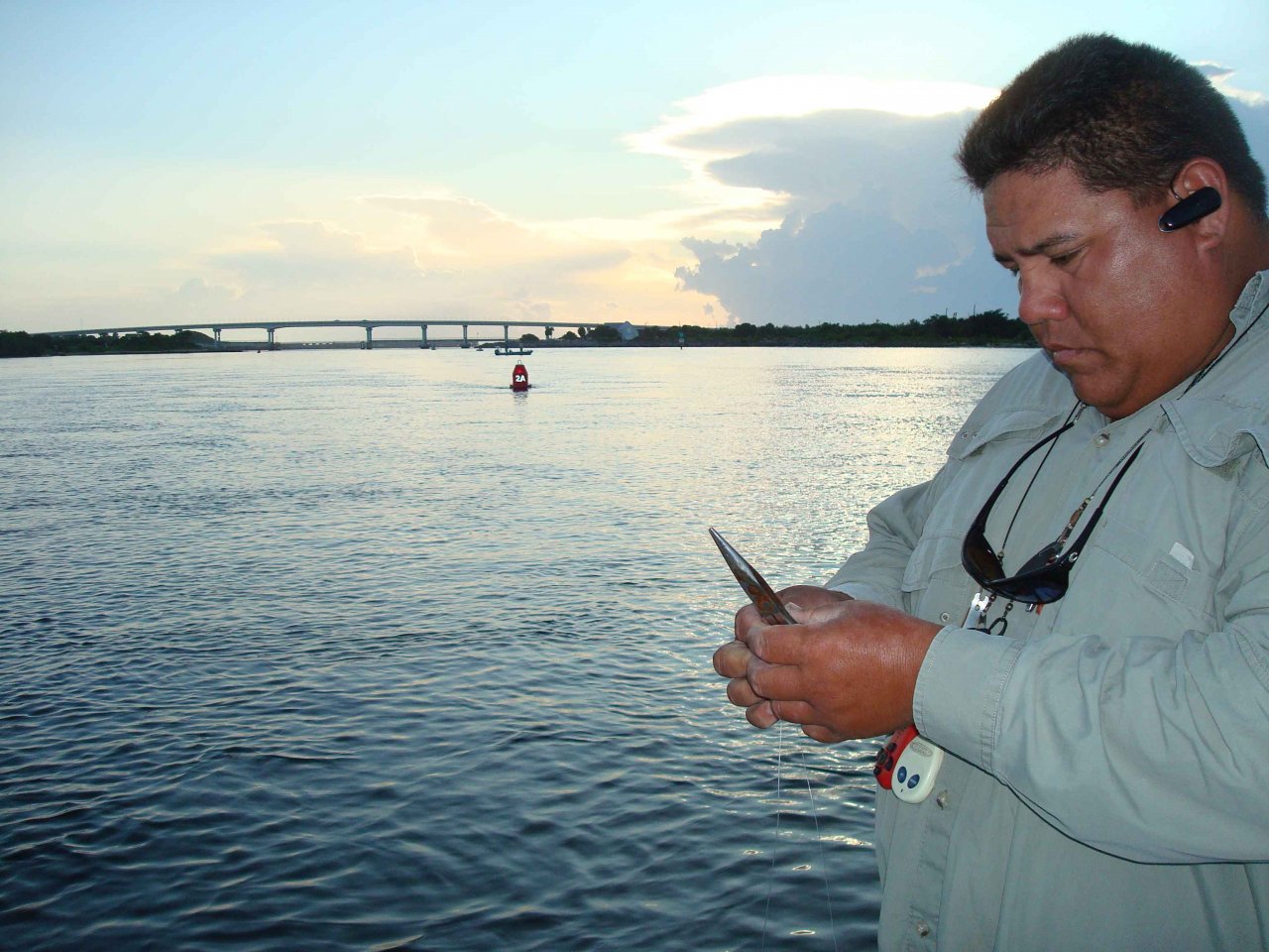 Guide Capt. Randy DuMars prepares for fly fishing in the early morning. Sebastian Inlet Bridge in the background