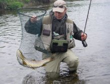 A huge trout safely in the net