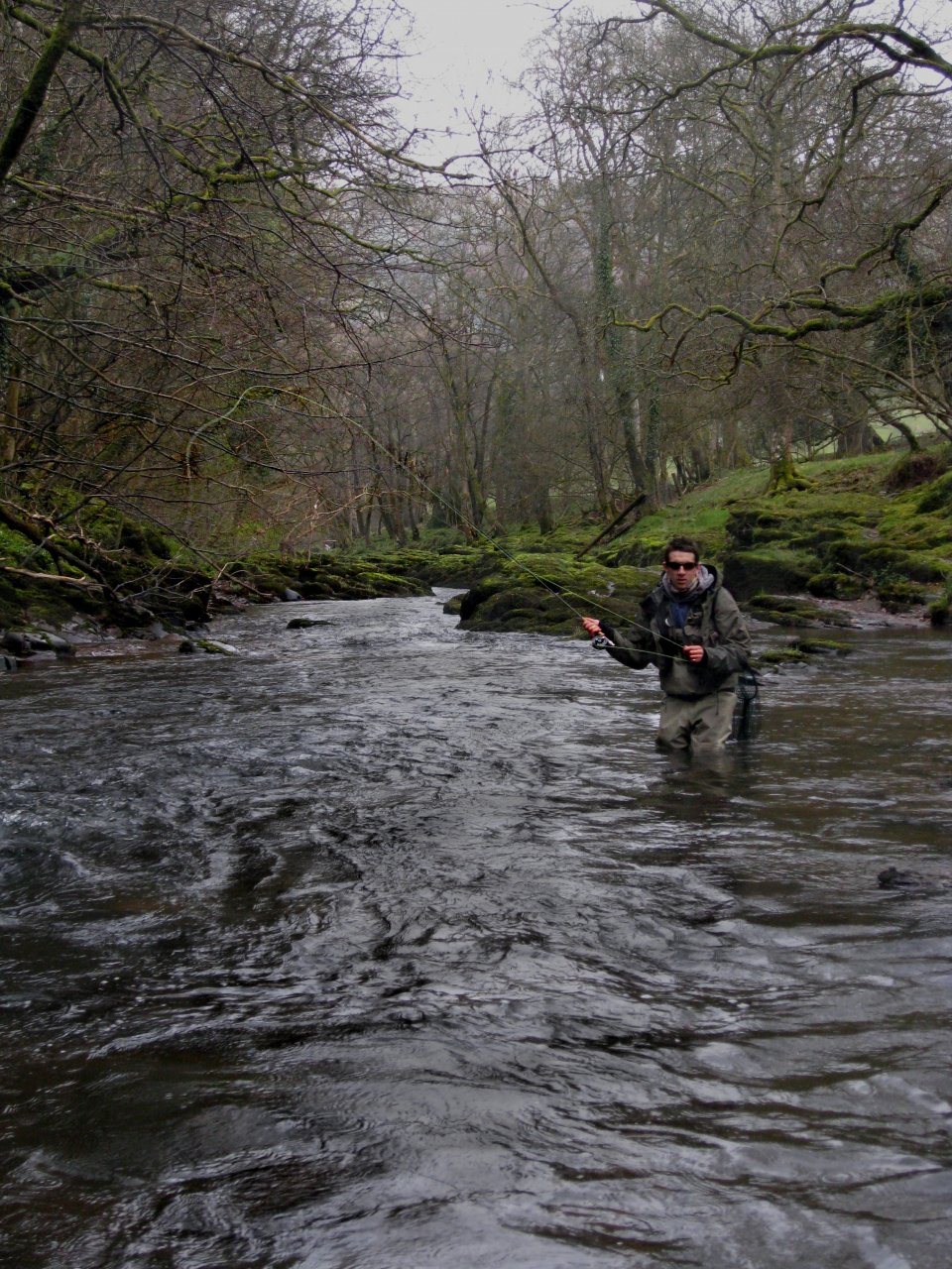 A fly fisherman fishing on the upper Usk