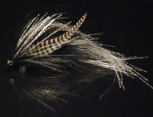 This one has been tied with black raccoon, white speckled Christmas tinsel, and grizzly microbarb saddles