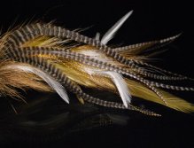 This is another replot stinger mack (II) tied with red and white raccoon fur, white Chinese cock saddles & hot orange microbarb saddles