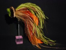This one is a combination of orange and brown schlappen mixed with Olive ostrich herl and tan bucktail. The head is a tightly packed spun deer hair head in tan dark brown and chartreuse