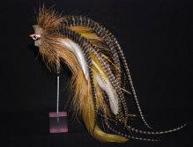This one has been tied with Olive and white chinese cock saddles, tan bucktail, plenty of grizzly microbarb saddles and a tightly packed spun deerhair head crimped together with a fishskull to give extra weight to the fly