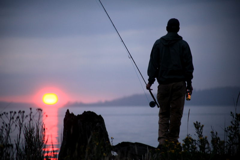 Ted McDermott watches the sun disappear while enjoying a cold one