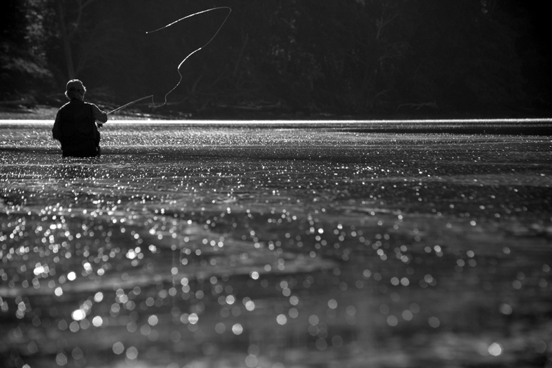   Black and White -- Nancy Harris casting on a perfectly flat day.  As the tide moves in on days like this, it slowly picks up sand particles and keeps them on the surface of the water