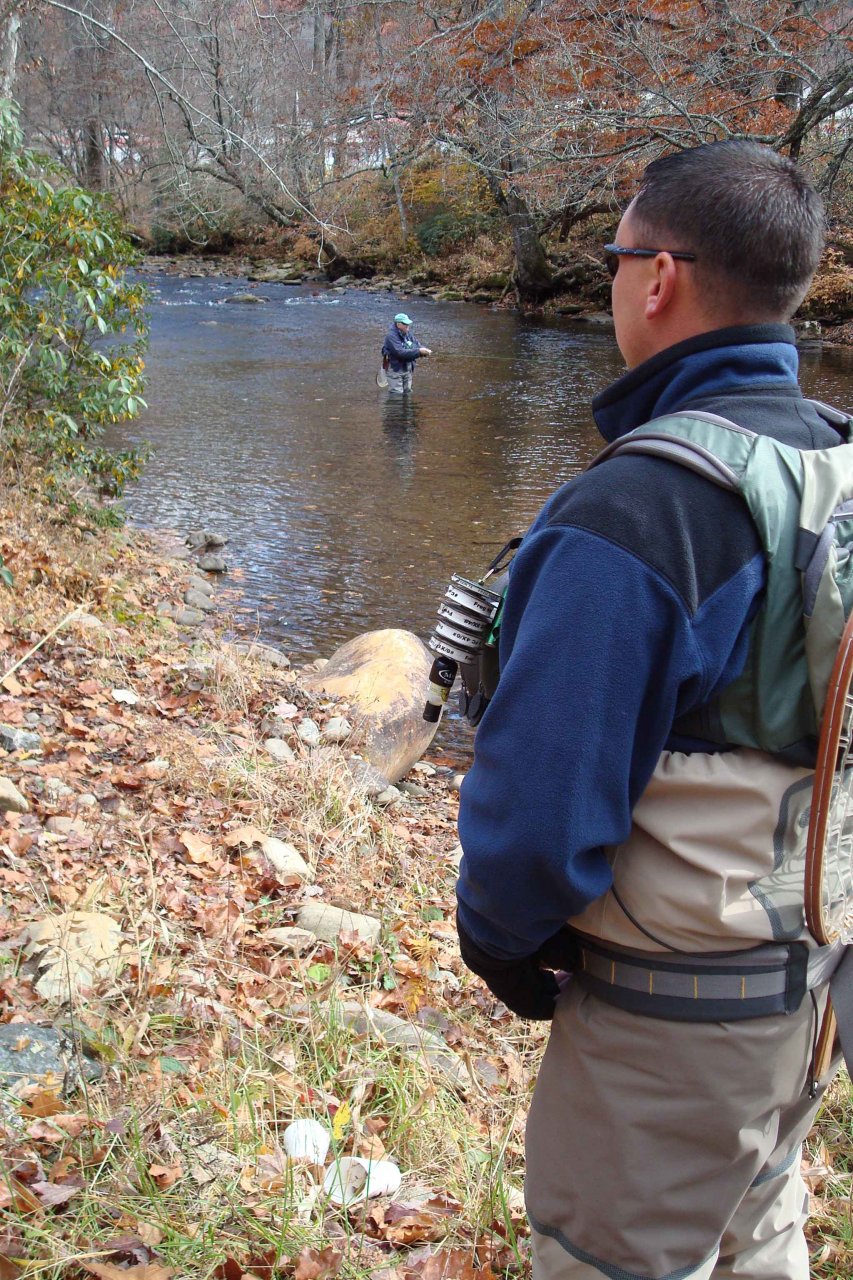 Guide Eugene Schular watches as Steve "NightCrawler" Patterson fishes a calm stretch of Raven's Fork