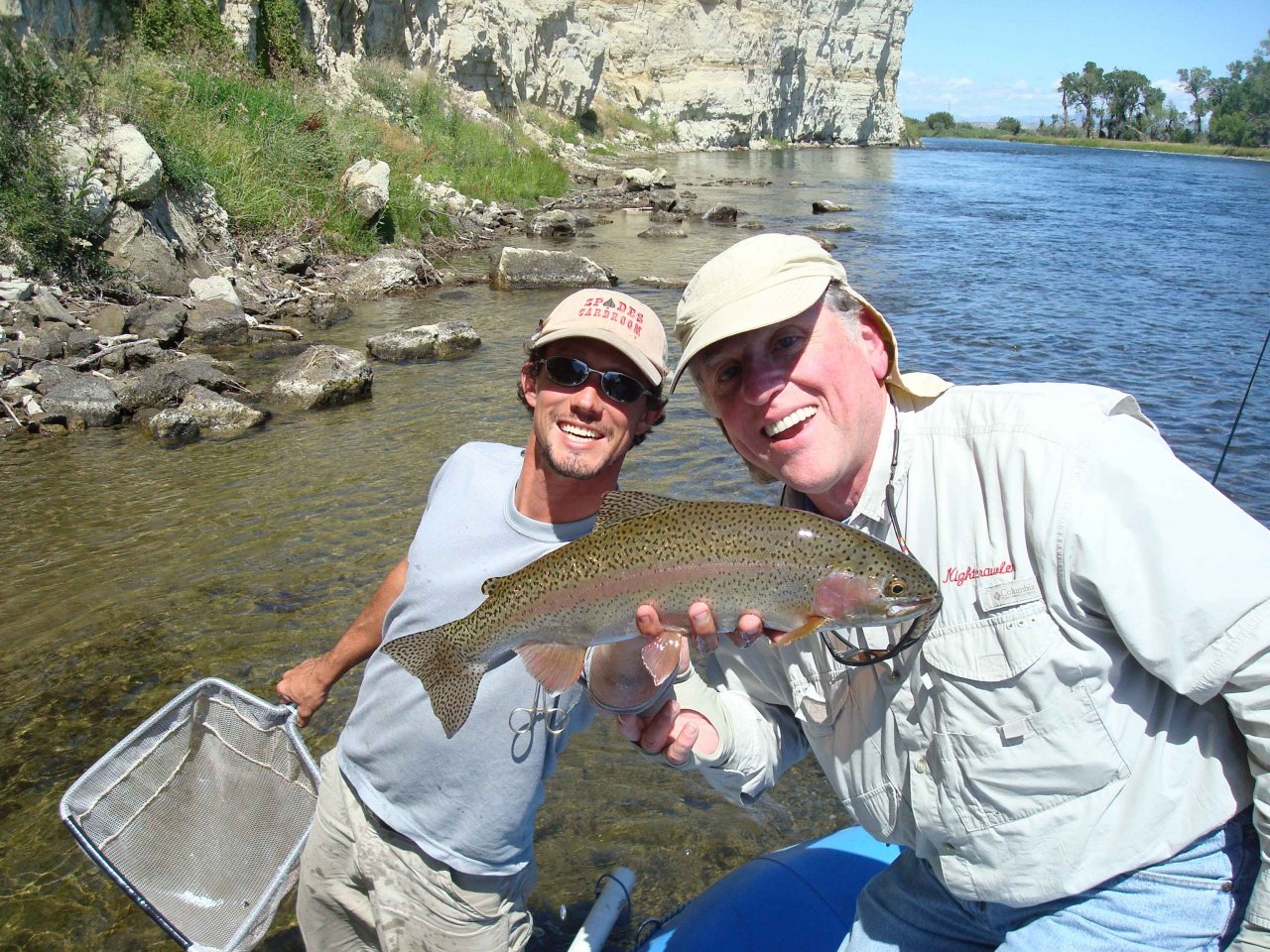 Guide Mike Spence holds rainbow trout caught by Steve Patterson